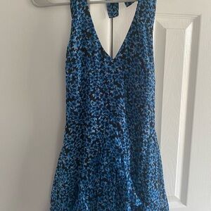 NWOT Mini halter dress with blue flowers on a black background.